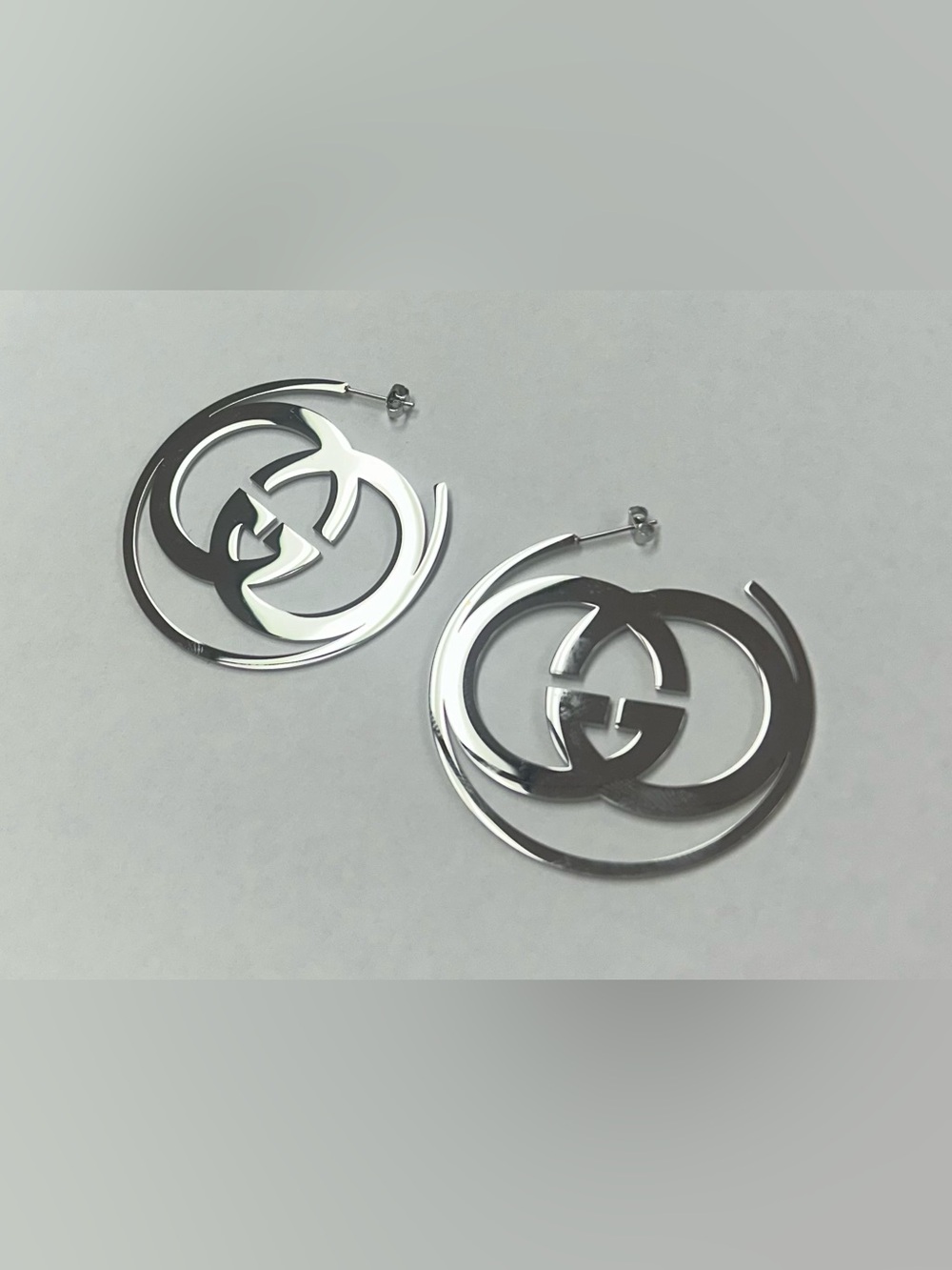 Silver-tone hoop earrings featuring the iconic interlocking Double-G logo.